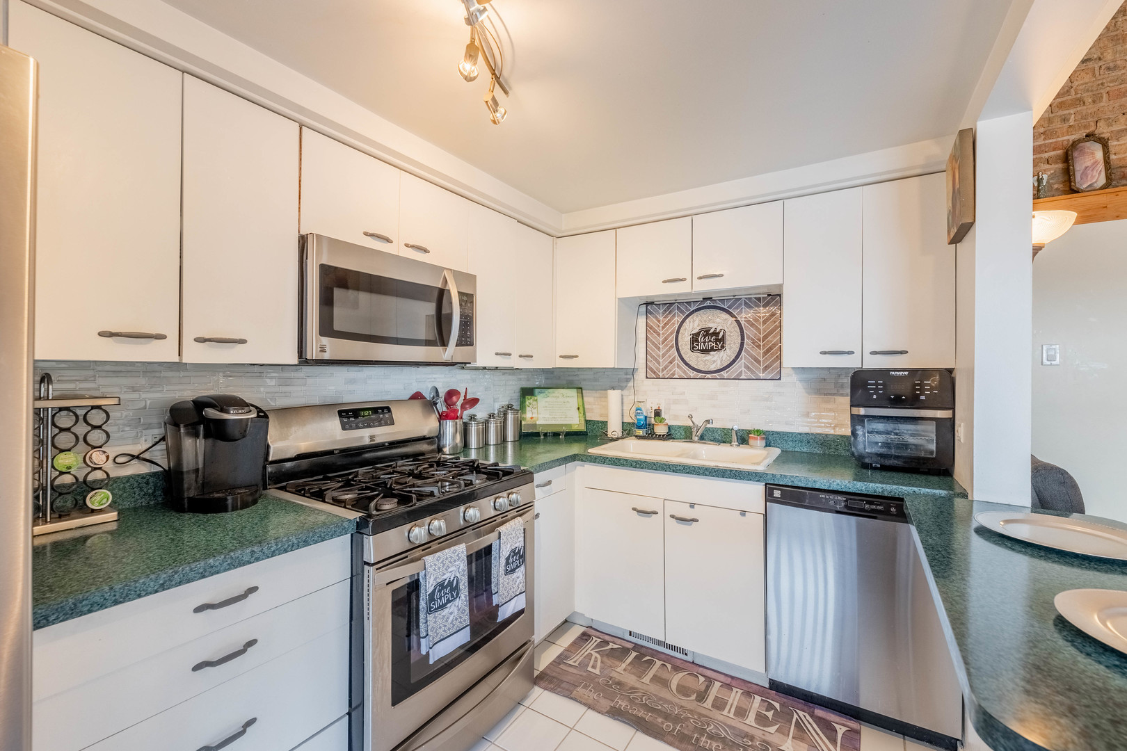 6337 Roosevelt Road, Unit 407 Berwyn, IL 60402 - Photo 13 of 30 a kitchen with stainless steel appliances granite countertop a sink a stove a microwave and cabinets