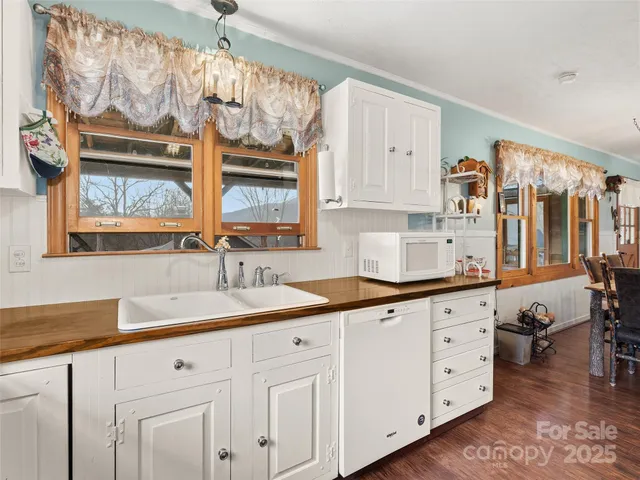 a kitchen with stainless steel appliances a refrigerator and a stove top oven