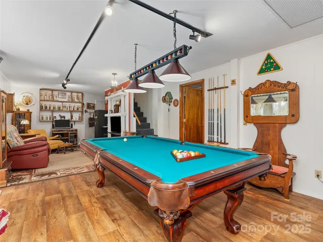 a room with pool tables and windows