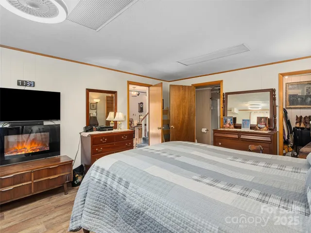 a bedroom with a bed and wooden floor