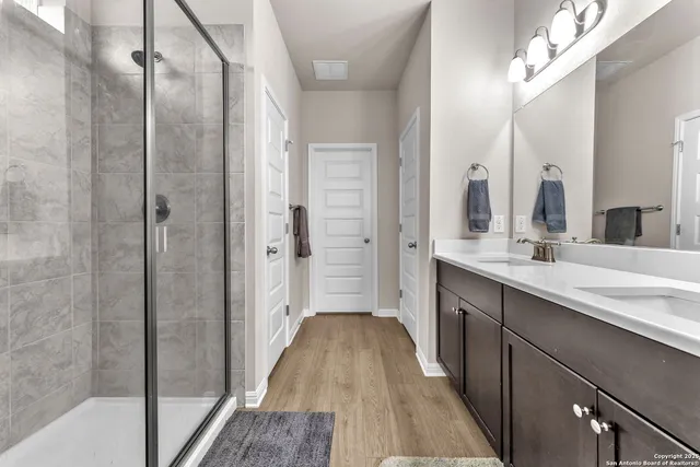a bathroom with a double vanity sink and a mirror