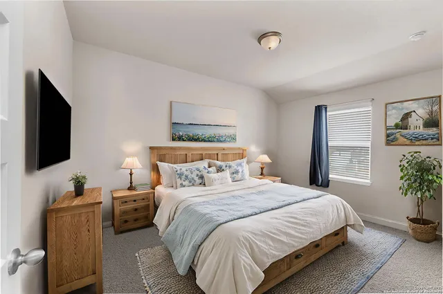 a bedroom with a bed and a window