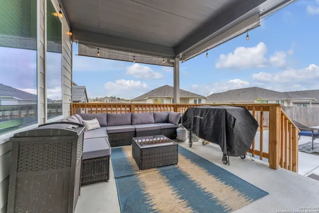 a roof deck with table and chairs and garden