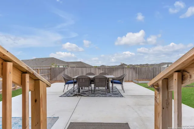 a view of a house with backyard and porch