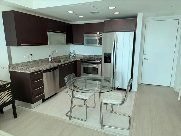 a living room with a flat screen tv and a floor to ceiling window