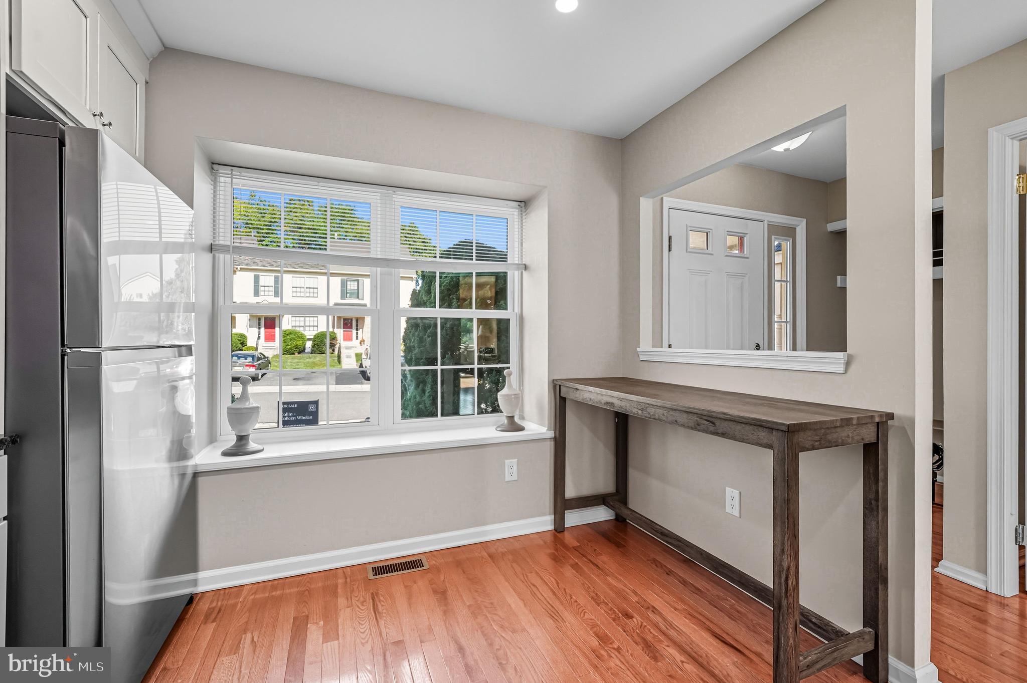 303 Scola Road Brookhaven, PA 19015 - Photo 12 of 56 a view of an empty room with a window and wooden floor