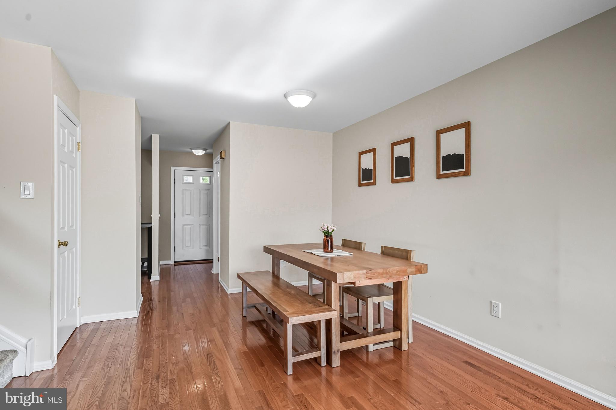 303 Scola Road Brookhaven, PA 19015 - Photo 16 of 56 a dining room with furniture and wooden floor