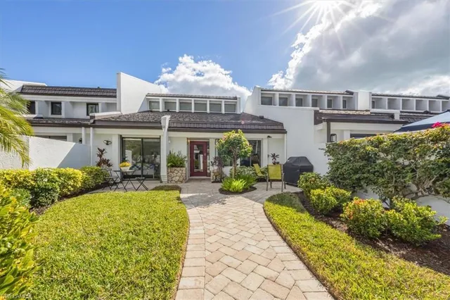 a view of a house with swimming pool and sitting area