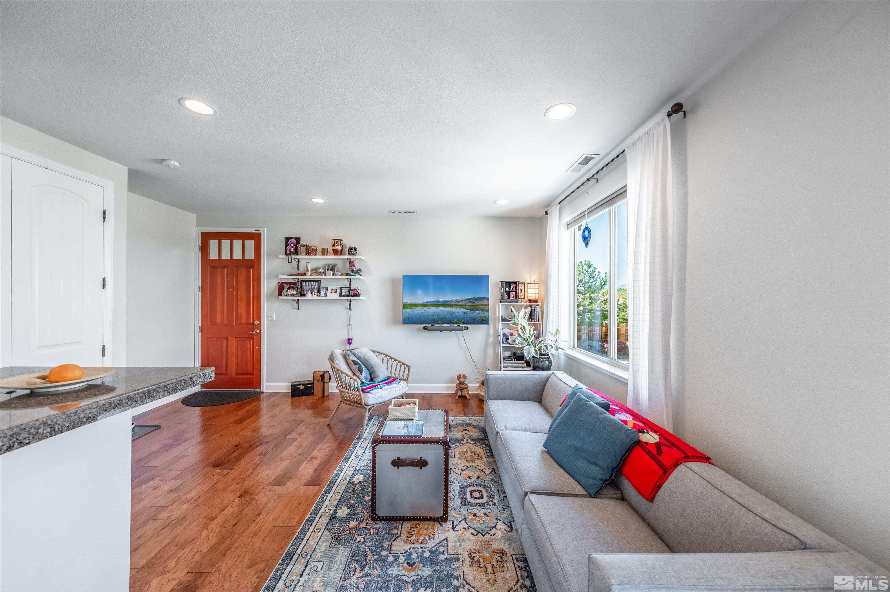 3677 Warren Way, Unit C Reno, NV 89509 - Photo 12 of 23 a living room with furniture and a wooden floor