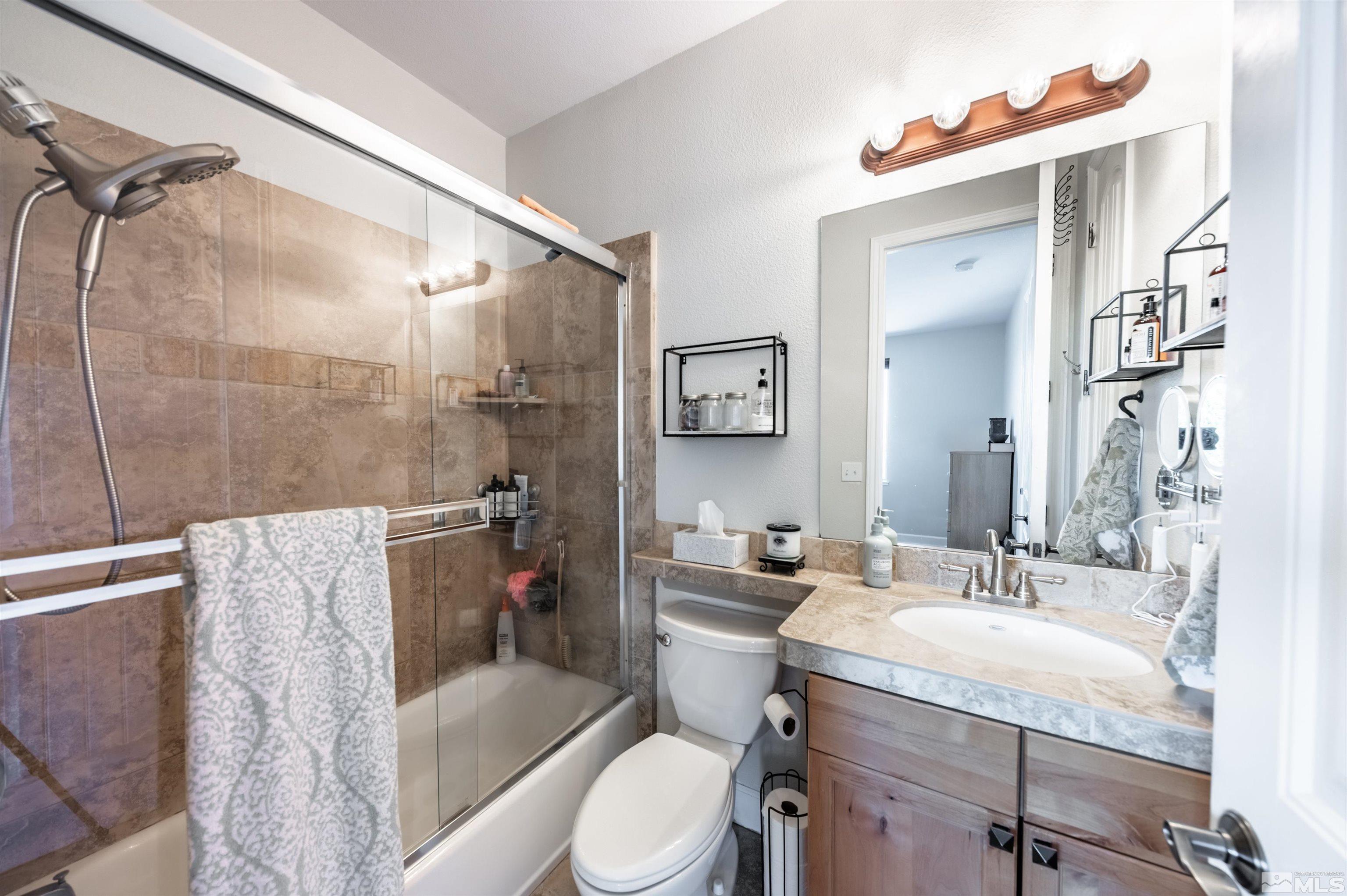 3677 Warren Way, Unit C Reno, NV 89509 - Photo 15 of 23 a bathroom with a granite countertop sink toilet and shower