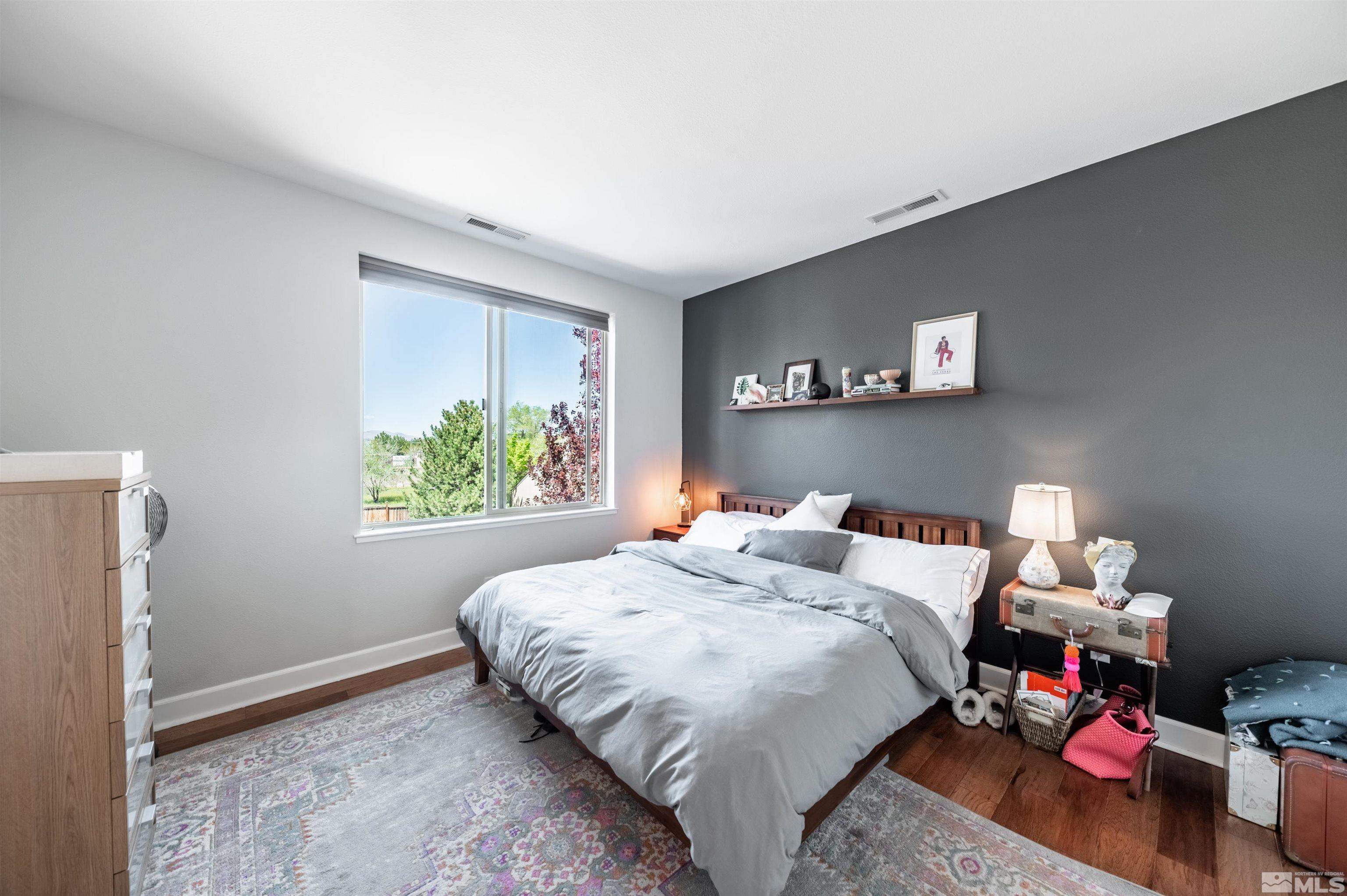 3677 Warren Way, Unit C Reno, NV 89509 - Photo 19 of 23 a bedroom with a bed and a window