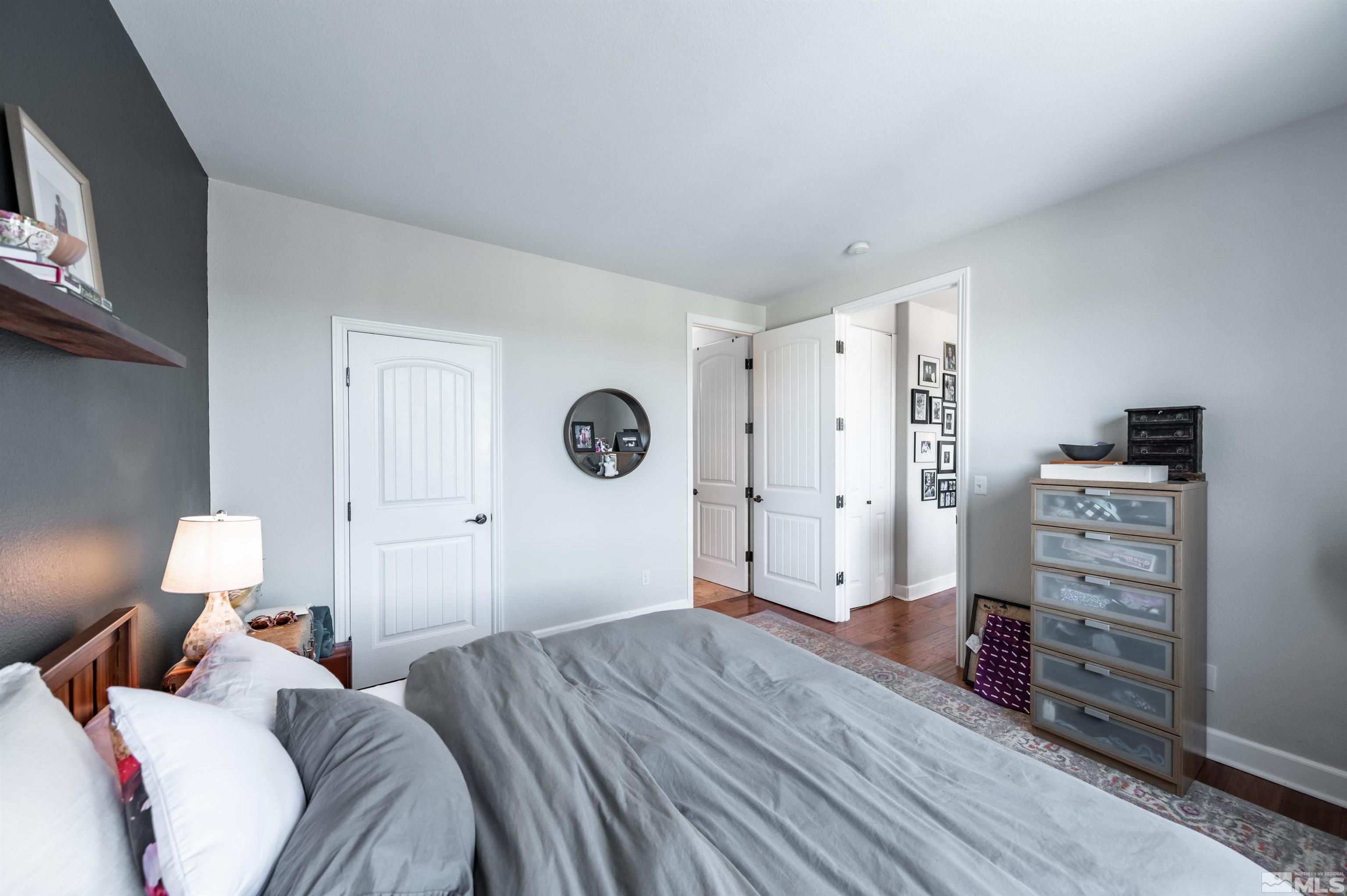 3677 Warren Way, Unit C Reno, NV 89509 - Photo 20 of 23 a bed room with a bed and a lamp