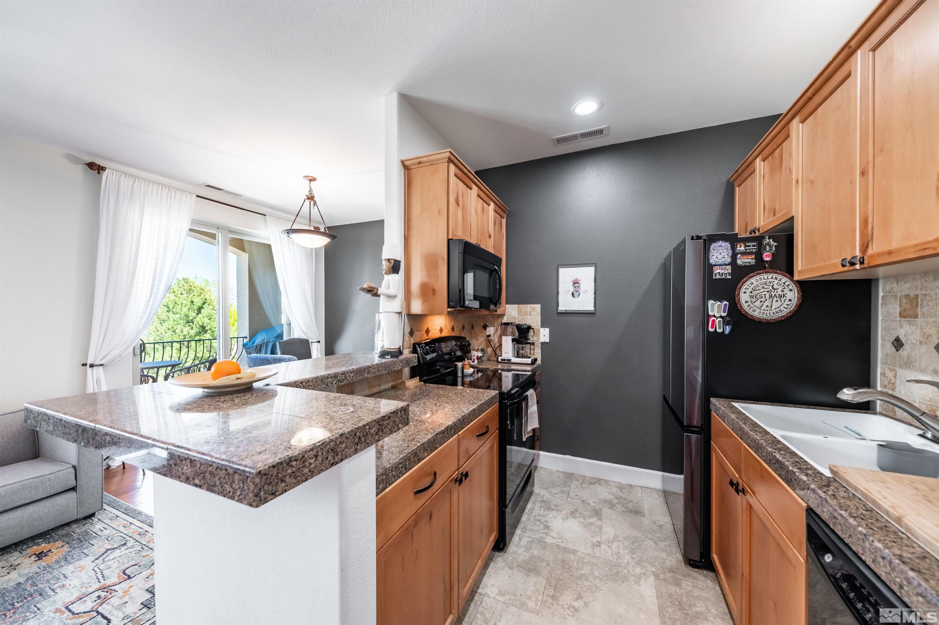 3677 Warren Way, Unit C Reno, NV 89509 - Photo 8 of 23 a kitchen with a stove a refrigerator and a stove