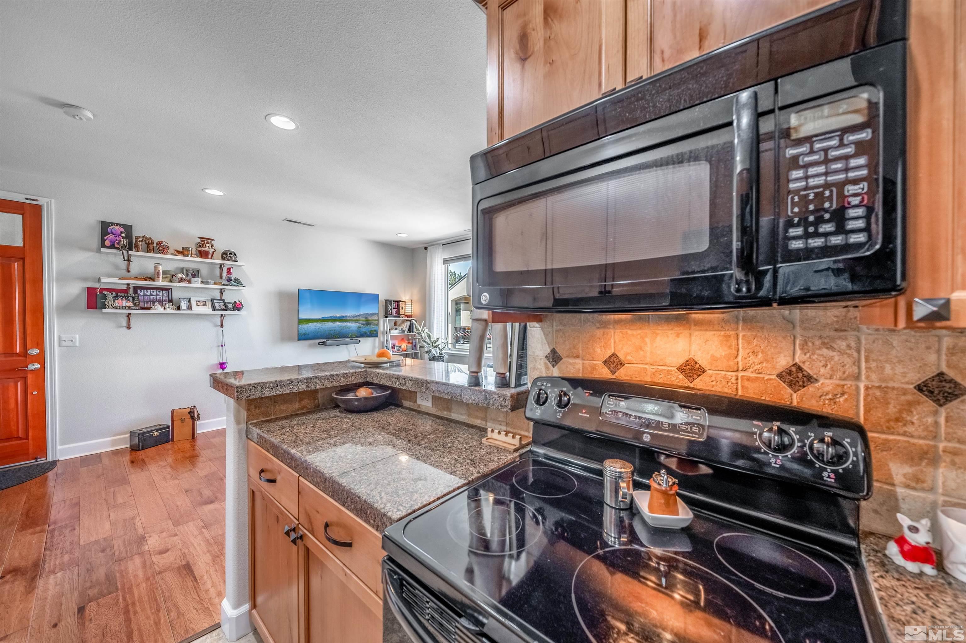 3677 Warren Way, Unit C Reno, NV 89509 - Photo 9 of 23 a kitchen with a stove and a microwave