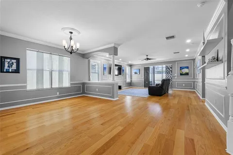 a view of kitchen and hall with wooden floor