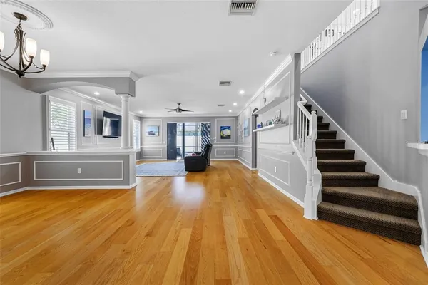 a view of livingroom with kitchen and wooden floor