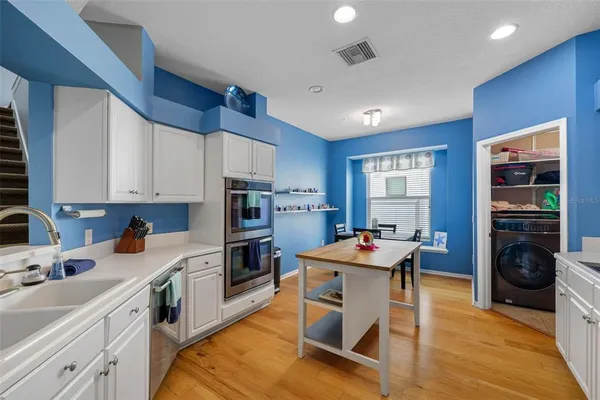 a kitchen with a sink stove and cabinets