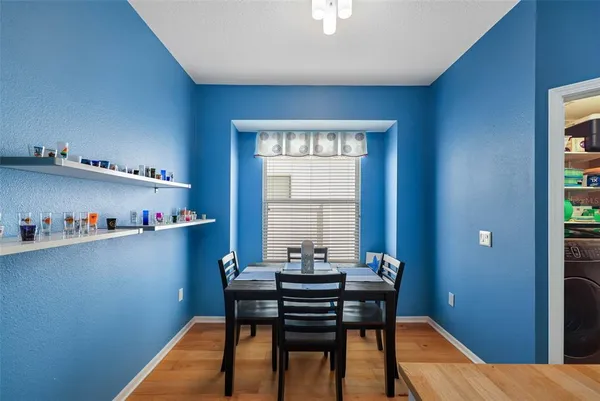 a view of a workspace with furniture and window