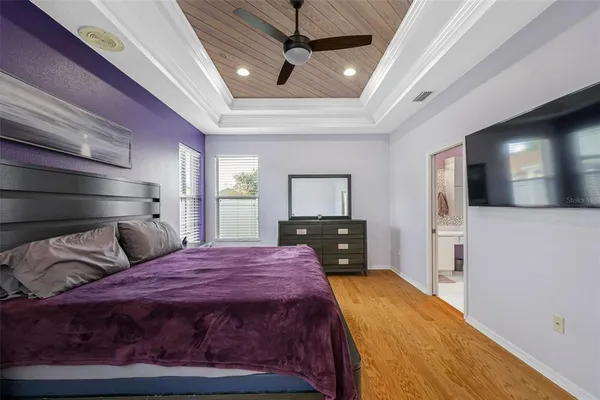 a bedroom with a large bed and a tv