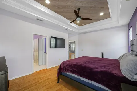 a bedroom with a large bed and a tv