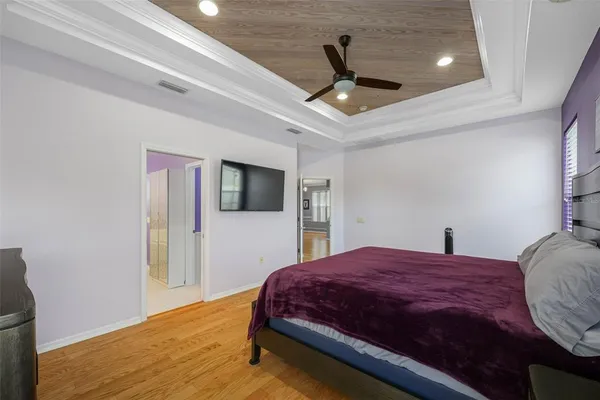 a bedroom with a large bed and a tv