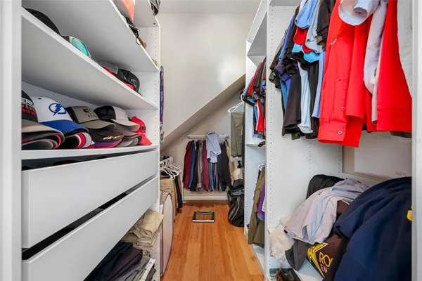 a view of a livingroom with furniture a ceiling fan and window