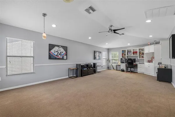 a view of a livingroom with furniture and a ceiling fan