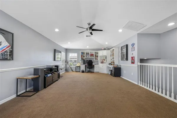 a view of a livingroom with furniture and a ceiling fan
