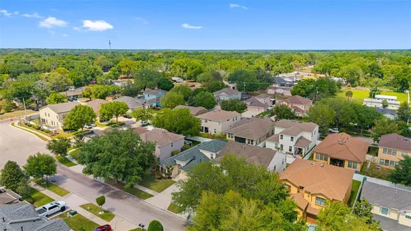 an aerial view of residential houses with outdoor space and street view