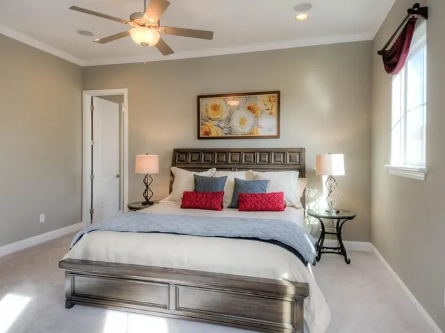 a bedroom with a bed and a chandelier