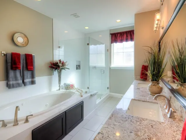 a bathroom with a granite countertop sink a toilet and a mirror