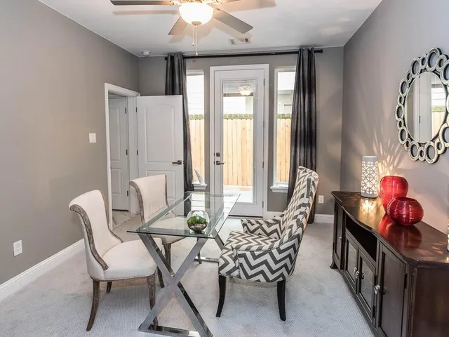 a dining room with furniture and window