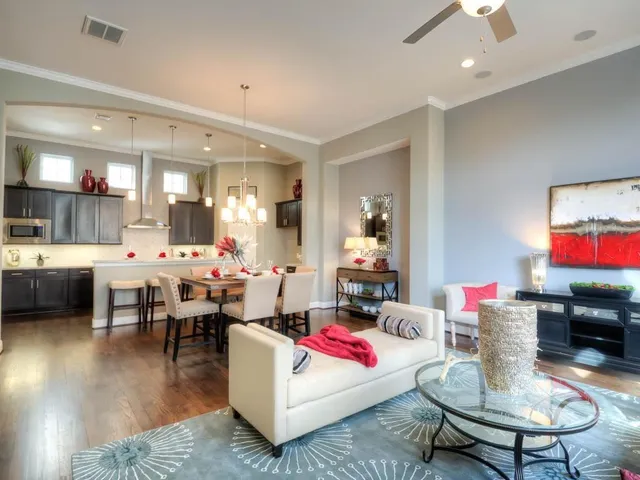 a living room with dining room and kitchen view