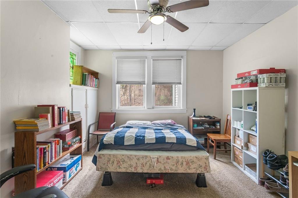 425 Braddock Road Pittsburgh, PA 15221 - Photo 11 of 39 a bedroom with furniture and a book shelf