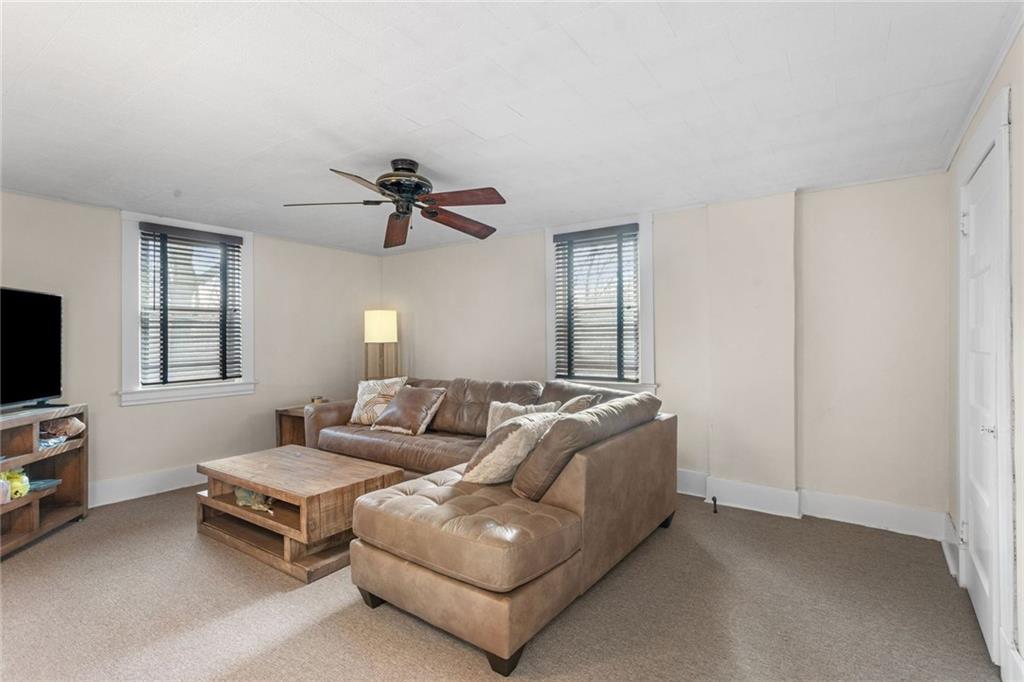 425 Braddock Road Pittsburgh, PA 15221 - Photo 16 of 39 a living room with furniture and a flat screen tv
