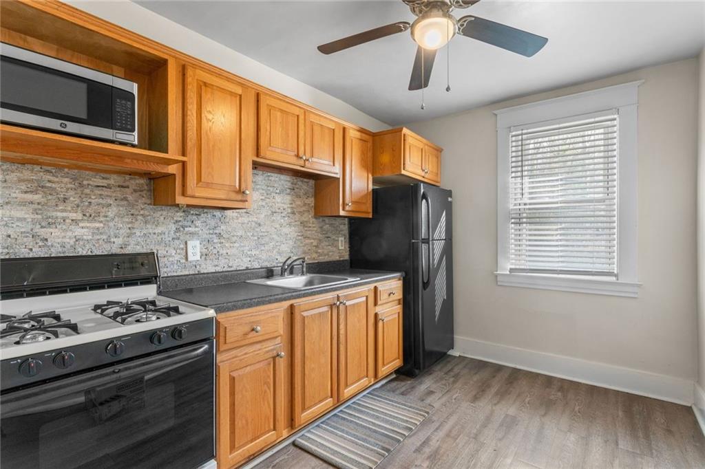 425 Braddock Road Pittsburgh, PA 15221 - Photo 20 of 39 a kitchen with stainless steel appliances granite countertop a stove a sink dishwasher and a refrigerator
