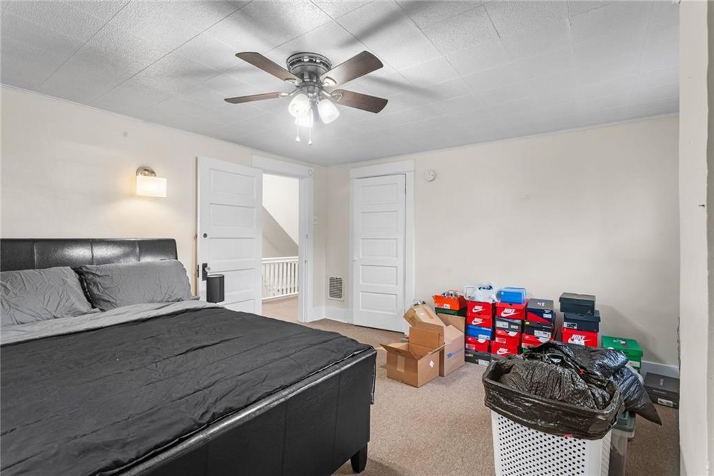 425 Braddock Road Pittsburgh, PA 15221 - Photo 21 of 39 a bedroom with furniture and a chandelier