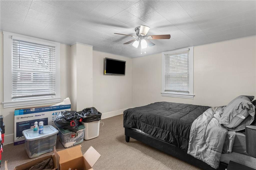 425 Braddock Road Pittsburgh, PA 15221 - Photo 22 of 39 a bedroom with a bed and a window
