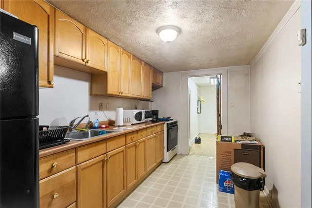 a kitchen with stainless steel appliances granite countertop a sink stove and cabinets