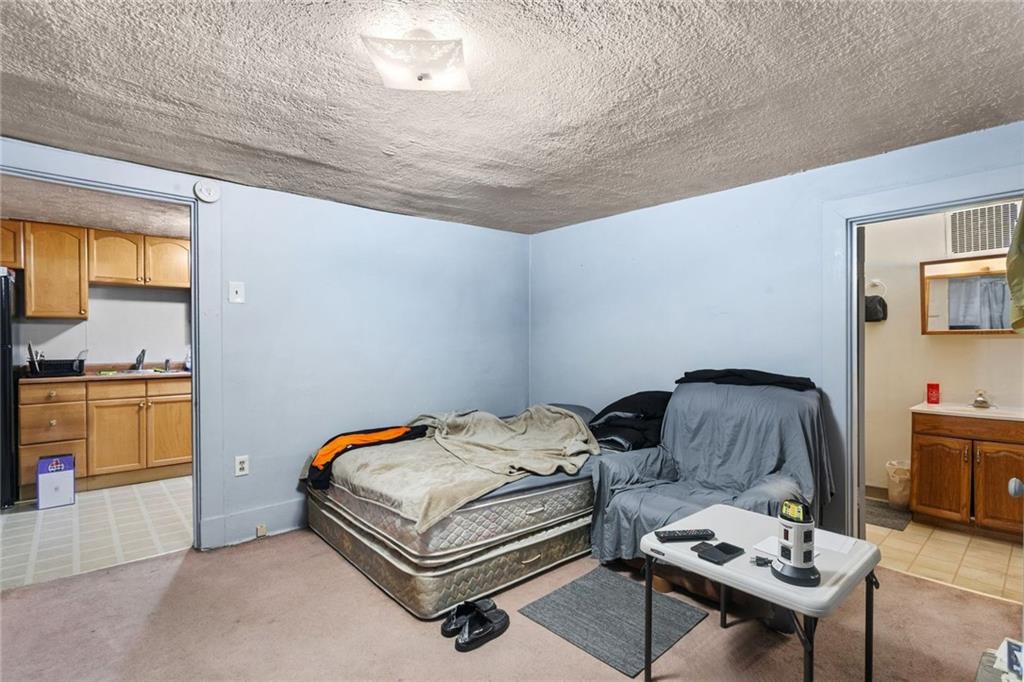 425 Braddock Road Pittsburgh, PA 15221 - Photo 30 of 39 a bedroom with bed and a couch