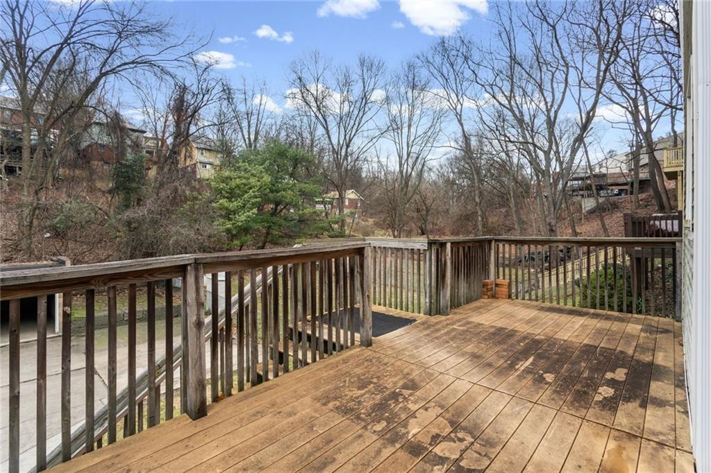 425 Braddock Road Pittsburgh, PA 15221 - Photo 36 of 39 a balcony with wooden floor and trees