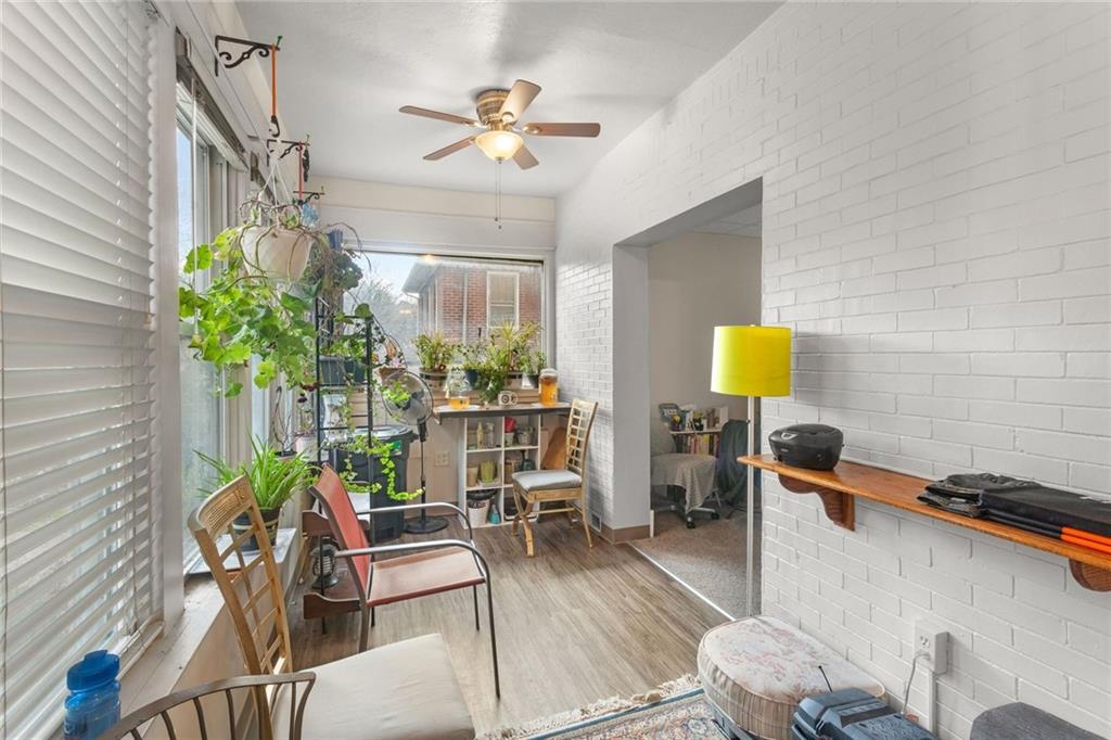 425 Braddock Road Pittsburgh, PA 15221 - Photo 4 of 39 a living room with furniture and a potted plant