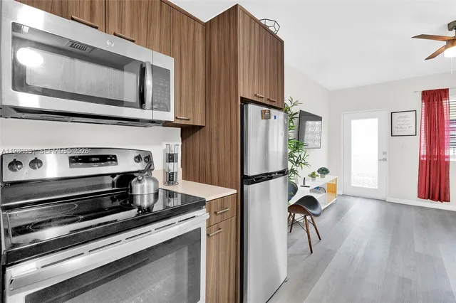 a kitchen with stainless steel appliances a stove a microwave and a refrigerator