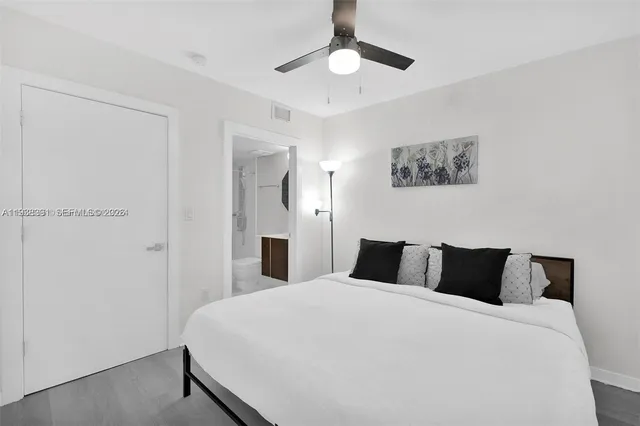 a bedroom with a bed and a painting on the wall