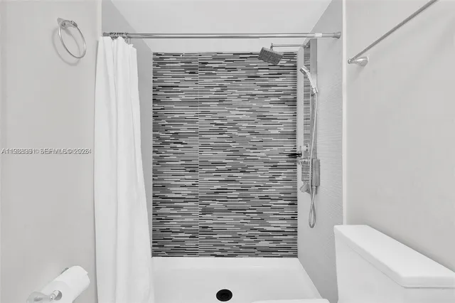 a bathroom with a shower and a toilet