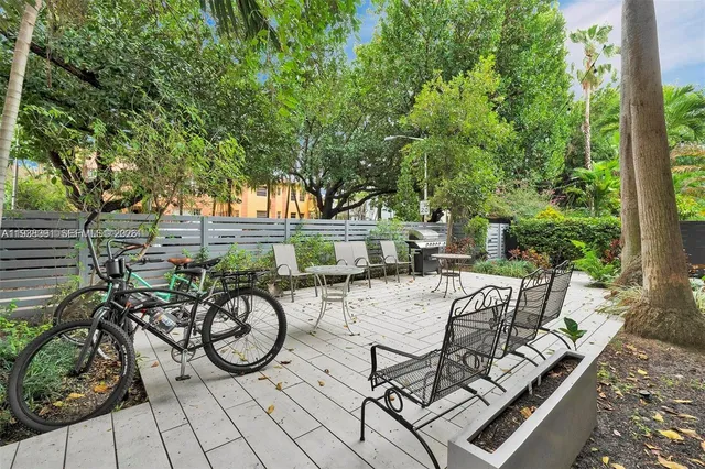 an aerial view of a house with a yard and large trees