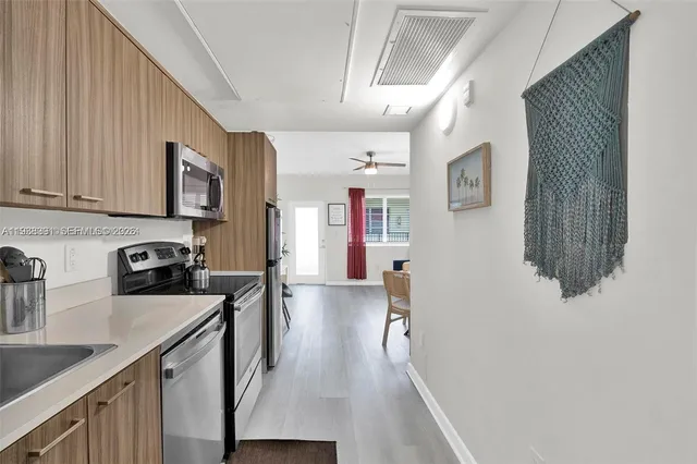 a kitchen with stainless steel appliances granite countertop lots of counter top space and cabinets