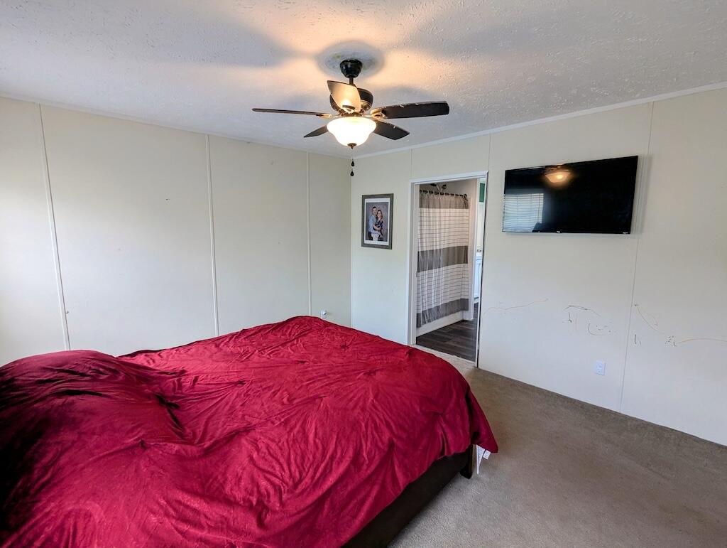 515 Windsor Road Northwest Willis, VA 24380 - Photo 11 of 30 a bedroom with a bed and a flat screen tv