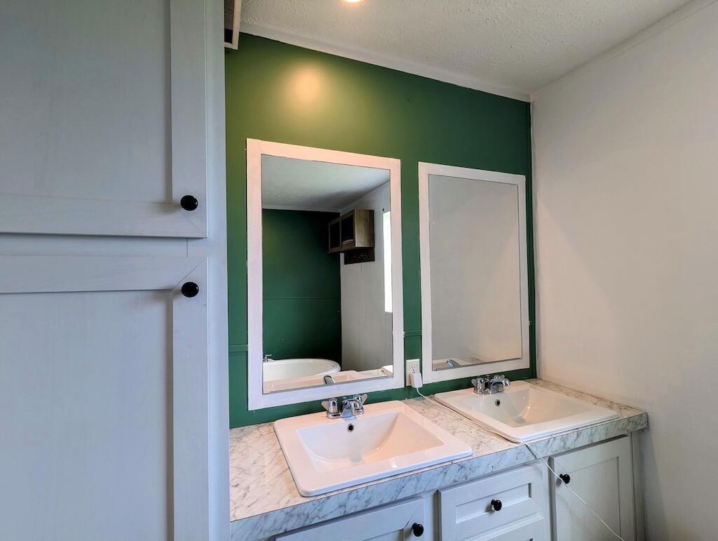 515 Windsor Road Northwest Willis, VA 24380 - Photo 13 of 30 a bathroom with a sink and a mirror