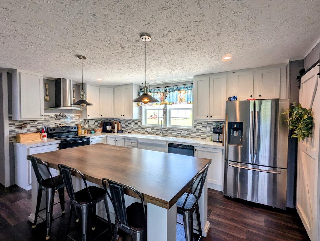 515 Windsor Road Northwest Willis, VA 24380 - Photo 5 of 30 a kitchen with refrigerator a center island and a refrigerator